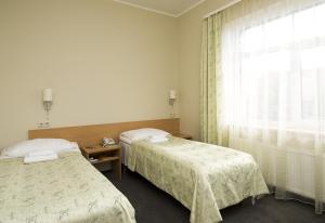 Postel nebo postele na pokoji v ubytování TOSS Hotel + 13 fotografií