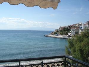 a view of the ocean from a balcony at Veroniki Apartment in Skala Marion