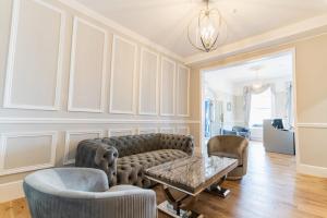 a living room with a couch and chairs and a table at The Pier Hotel in Eastbourne