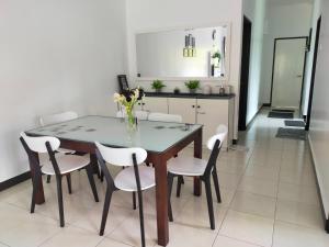 a dining room with a table and chairs at 80'S PARADISE in Tanah Rata