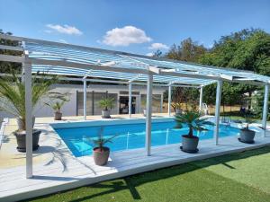a pergola over a swimming pool with potted plants at SRB Sadovo-Resort-Bulgaria in Sadovo