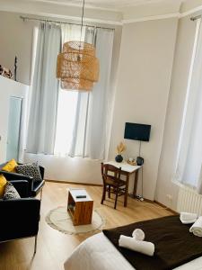 a living room with a bed and a couch and a table at Hotel Du Parlement in Brussels