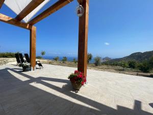 a patio with chairs and a potted plant on it at David in Cefalù +3 photos