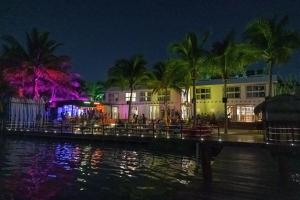 a resort at night with a body of water at The Yak Lake House - Hostal in Bacalar