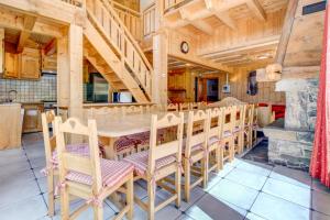 a dining room with a wooden table and chairs at Aconits in Morzine