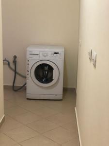 a washer and dryer in a room with a refrigerator at Sunset Apartments Berdenesh Sarandë in Sarandë
