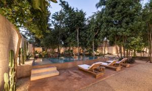 a swimming pool with two lounge chairs and a swimming pool at Casona los Cedros in Espita
