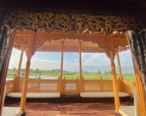 a wooden gondola with a view of a field at Green Paradise Houseboat - Centrally Heated in Srinagar