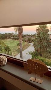 a window with a view of a palm tree at Villa Maris Capo Vaticano in Capo Vaticano