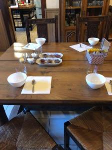 a wooden table with bowls of food on it at chambres d'hôtes Etche Iza in Hosta +11 photos