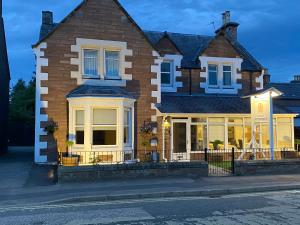 a house on a street in front of a street at Adrian's Guest House in Inverness