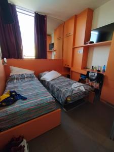 a bedroom with two beds and a window in it at Hotel Prestigio in Cesenatico