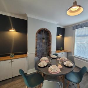 a dining room with a table and chairs at The little seaside cottage in Bridlington