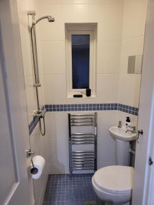 a bathroom with a toilet and a sink at The little seaside cottage in Bridlington