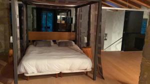 a bedroom with a canopy bed in a room at Casa Rural el Serrat de Baix in Sant Joan les Fonts