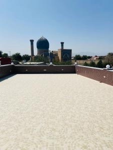 a view of a roof with a building in the background at Hotel Grand Marakand in Samarkand