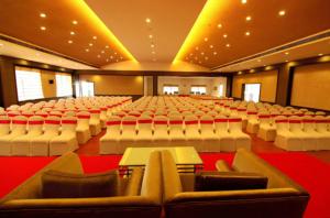 a large auditorium with rows of chairs and tables at Paravoor Galaxy Hotel in Cherai Beach