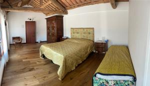 a bedroom with two beds and a wooden floor at Villa Iside in Chirignago