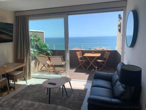 a living room with a couch and a view of the ocean at SOLARIS PANORAMIC studio vue mer in Portimão +13 photos