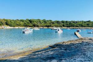 a group of boats in a large body of water at Beautiful apartment at entrance to Cape Kamenjak in Premantura