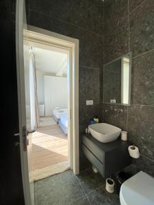 a bathroom with a sink and a mirror at Getaway Room Palase in Palasë