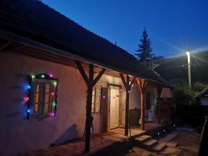 a house with christmas lights on the windows of it at Róza Vendégház in Buják