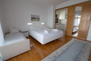 a bedroom with two beds and a living room at APARTMENTs MARIJA SENJ in Senj