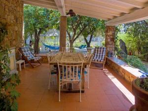 a wooden table and chairs on a patio at B&B I Mari in Torpè