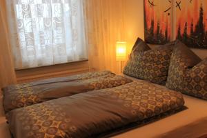 two beds sitting on a couch with a window at Ferienwohnung K+M+B am Ossiacher See - Jerry in Bodensdorf +9 photos