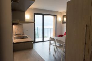 a kitchen and dining room with a table and a view at Residenza Luigina in Varenna