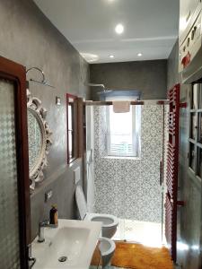 a bathroom with a sink and a toilet and a window at tita's house in Lucca +34 photos