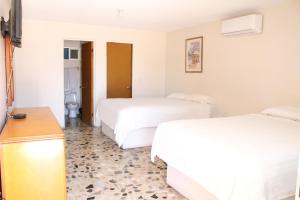 Ένα ή περισσότερα κρεβάτια σε δωμάτιο στο Empalme inn