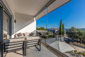 a balcony with a couch and a view of the ocean at Apartment Rippl II in Crikvenica