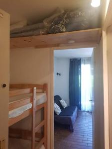 a room with two bunk beds and a couch at Studio Mag'Aline in Saint-Cyr-sur-Mer