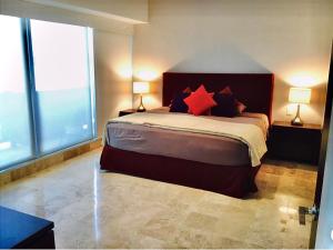 a bedroom with a large bed with red pillows at Oceanview Luxury, Pool, Near Tour Boats & Beach in Puerto Vallarta +24 photos