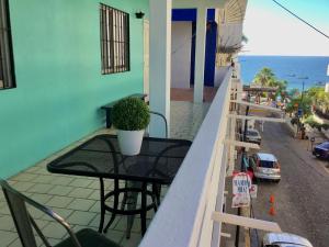 a balcony with a table with a potted plant on it at One Bedroom Condo Near Beach RG6 in Puerto Vallarta