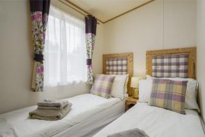 Tempat tidur dalam kamar di Dunroamin Lodge