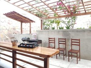 a table and two chairs and a grill on a patio at Bella Vista condominio in Canoas de Punta Sal