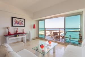 a living room with a view of the ocean at Casa de Coco in Puerto Vallarta