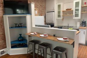 a kitchen with a counter with stools in it at Lower east side Nyc in Old Bisbee in Bisbee