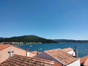 a view of the water from the roofs of houses at A Casa de Lolita in Muros