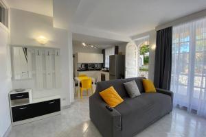 a living room with a couch and a kitchen at I Limoni Capri Apartment in Capri