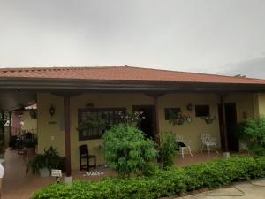 a house with a porch with chairs and plants at Bienvenidos a Guararé in Los Santos