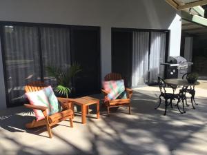 eine Terrasse mit 2 Stühlen, einem Tisch, einem Tisch und Stühlen in der Unterkunft Port Elliot rural retreat in Port Elliot