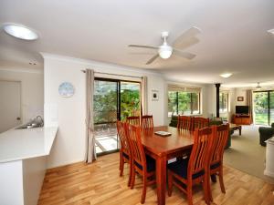 a dining room and living room with a table and chairs at All Decked Out in Hawks Nest