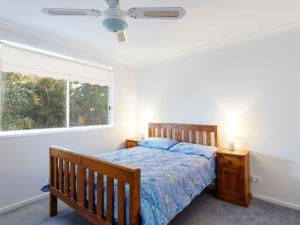 a bedroom with a bed and a window at Three Bedroom Townhouse in Hawks Nest