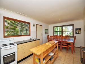 a kitchen and dining room with a table and chairs at Brilliant Location in Tea Gardens
