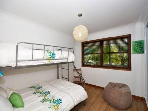 a bedroom with two bunk beds and a window at Brilliant Location in Tea Gardens
