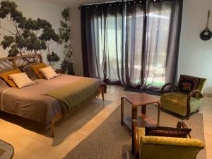 Postel nebo postele na pokoji v ubytování Chambre en Drôme Tropicale