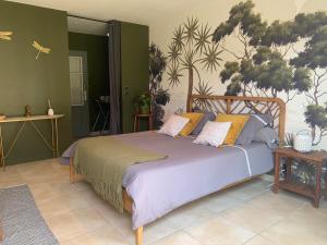 a bedroom with a large bed with pillows on it at Chambre en Drôme Tropicale in Chabeuil